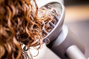 Drying long, curly hair using a hairdryer with a diffuser attachment